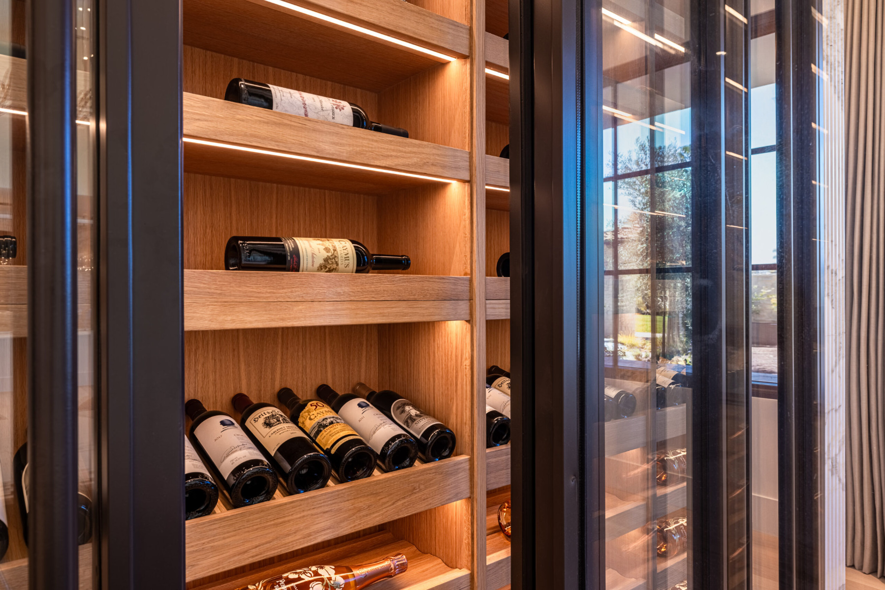 Close up of white oak wine cellar with lighting in Rancho Santa Fe California