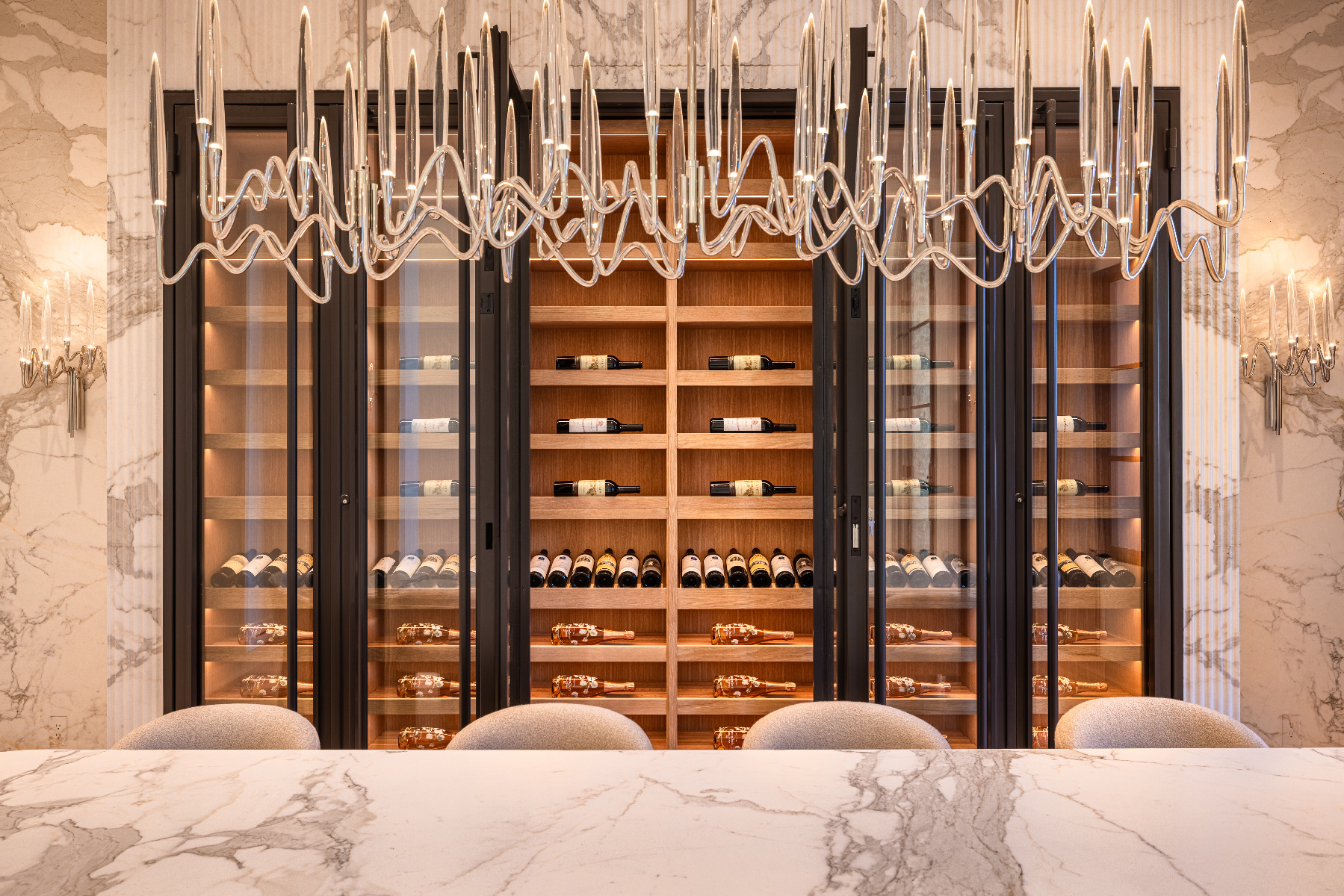 Opened white oak wine cellar in front of chandelier in Rancho Santa Fe California
