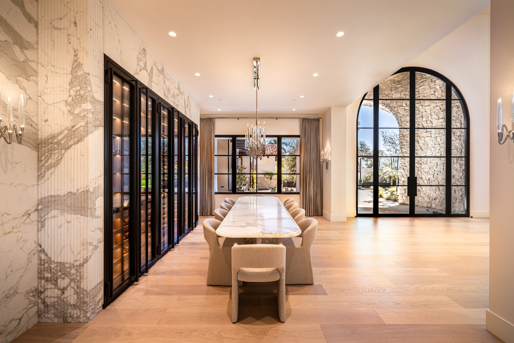 White oak wine cellar inside dining room with windows in Rancho Santa Fe California