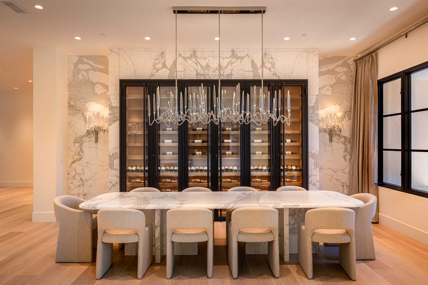 White oak wine cellar in front of marble dining table in Rancho Santa Fe California